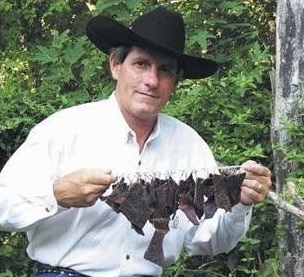 Larry Burrier with some homemade wild game jerky.