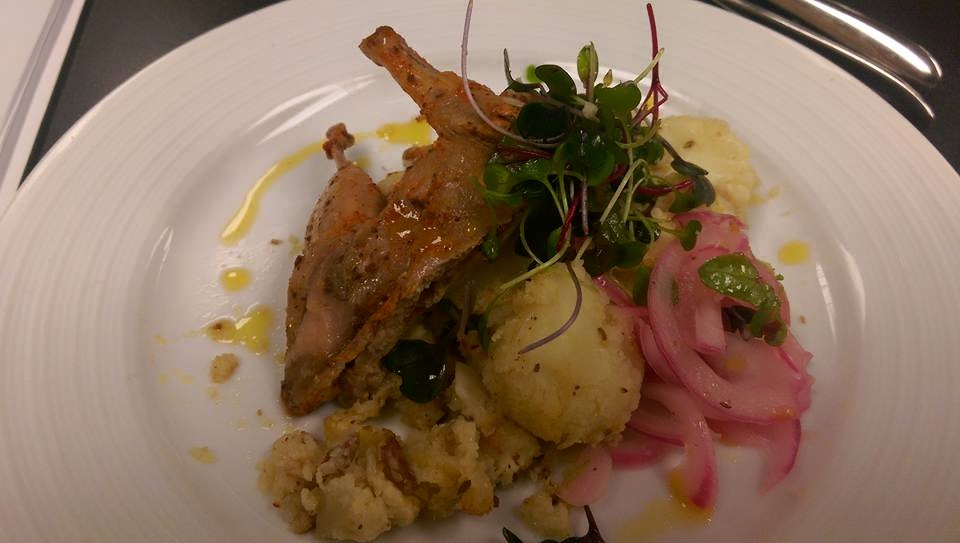 Quail, smashed cauliflower and pickled onions, topped with microgreens.