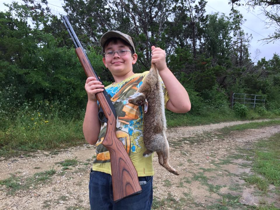 Evin's son, Tristan, with cottontail he harvested.